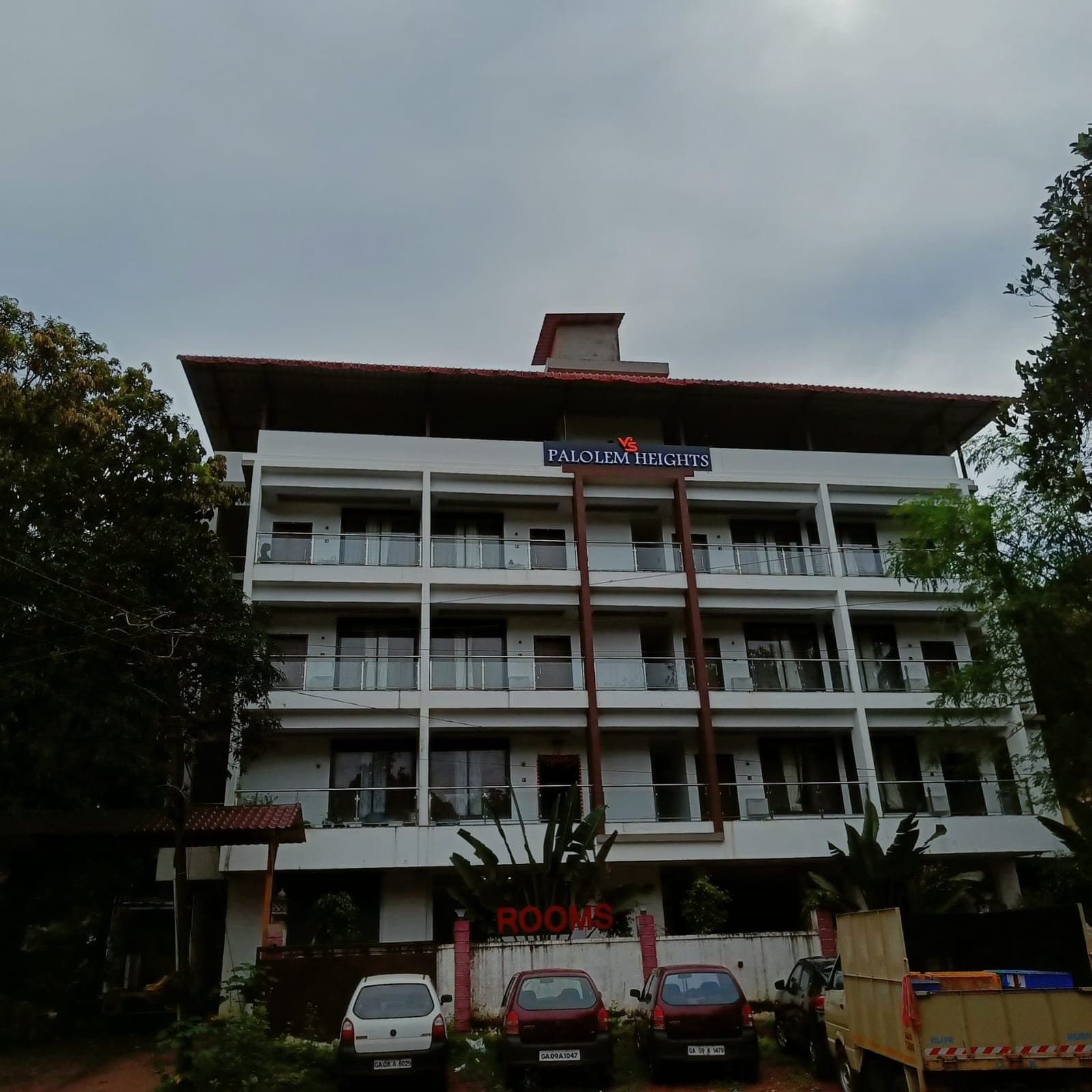 The Palolem Heights house — four storeys of balconies above the trees of Nagarcem